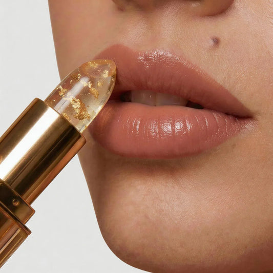 Clear lipstick bullet with decorative gold-tone flecks