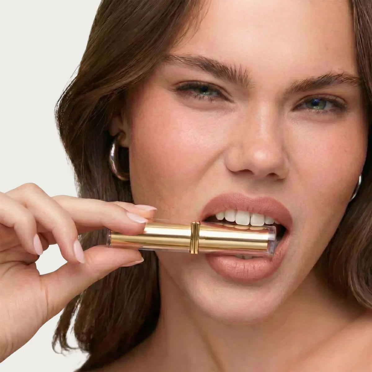Gold-tone lipstick case and lip makeup styling